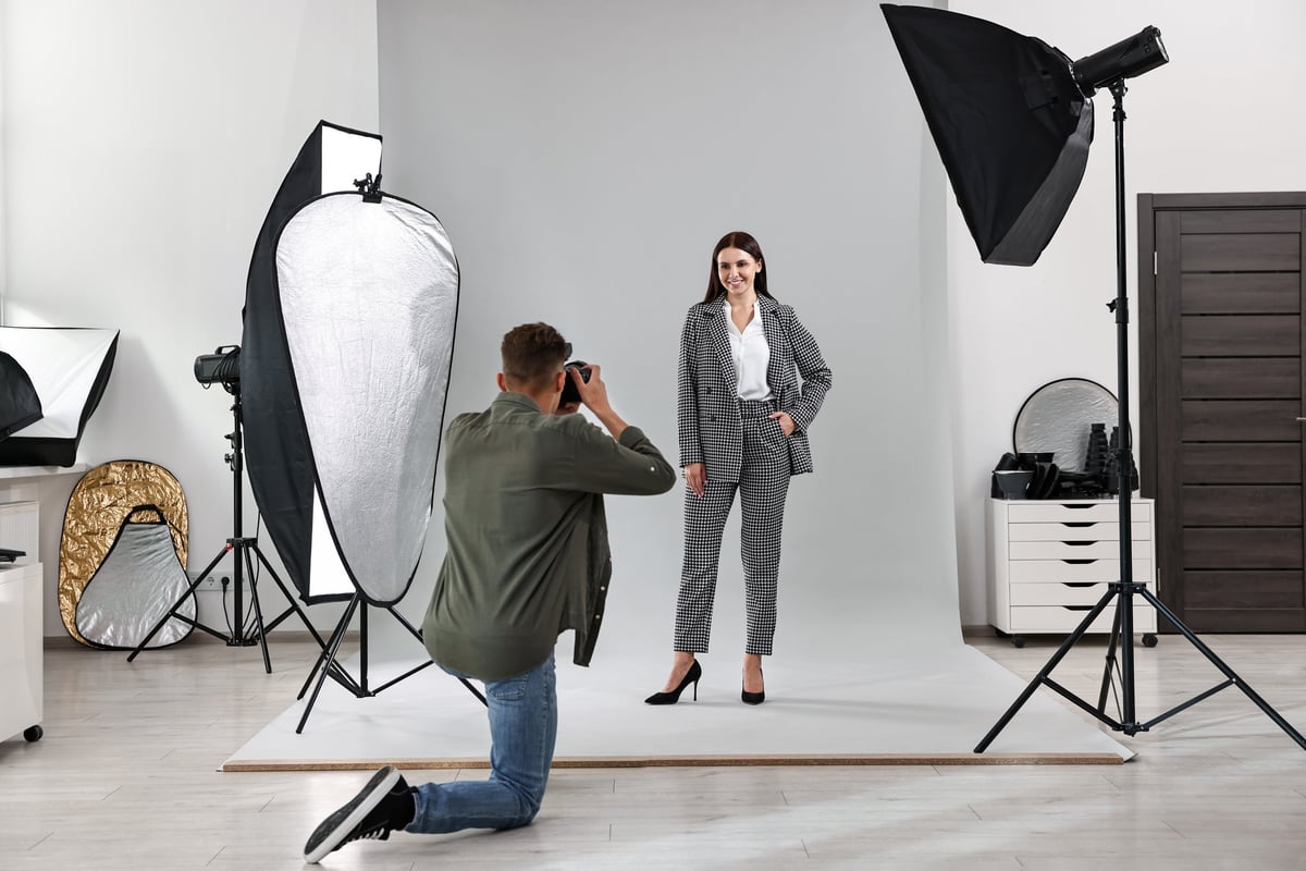 Professional photographer working with model in a commercial photo studio