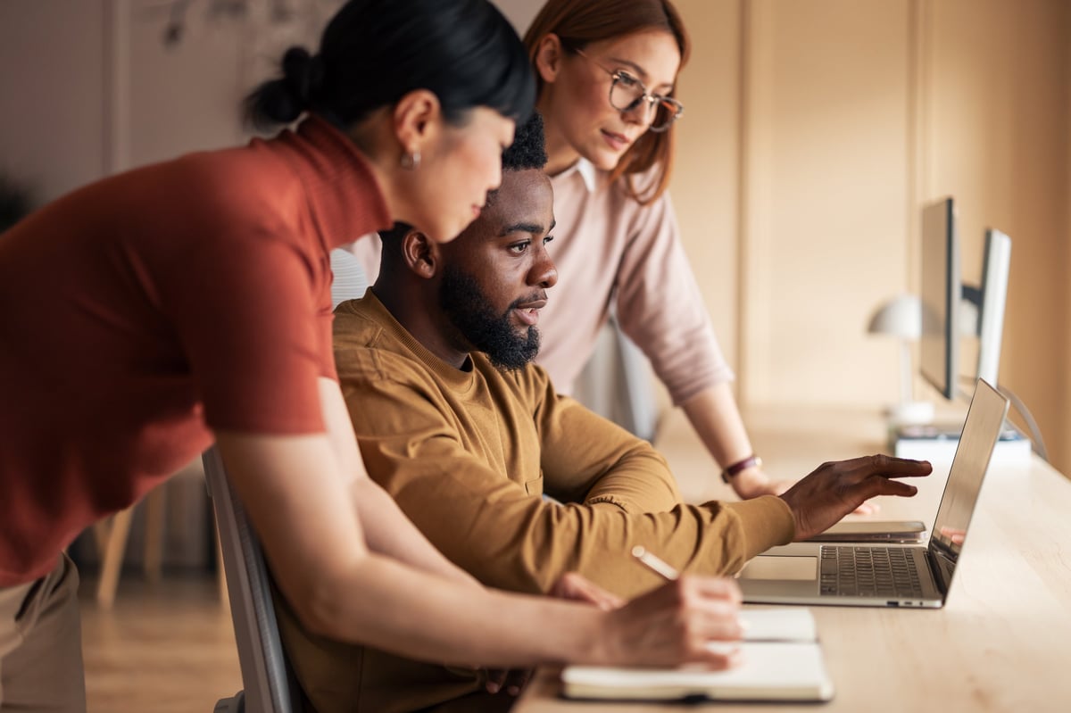 Digital marketing team collaborating in modern office workspace
