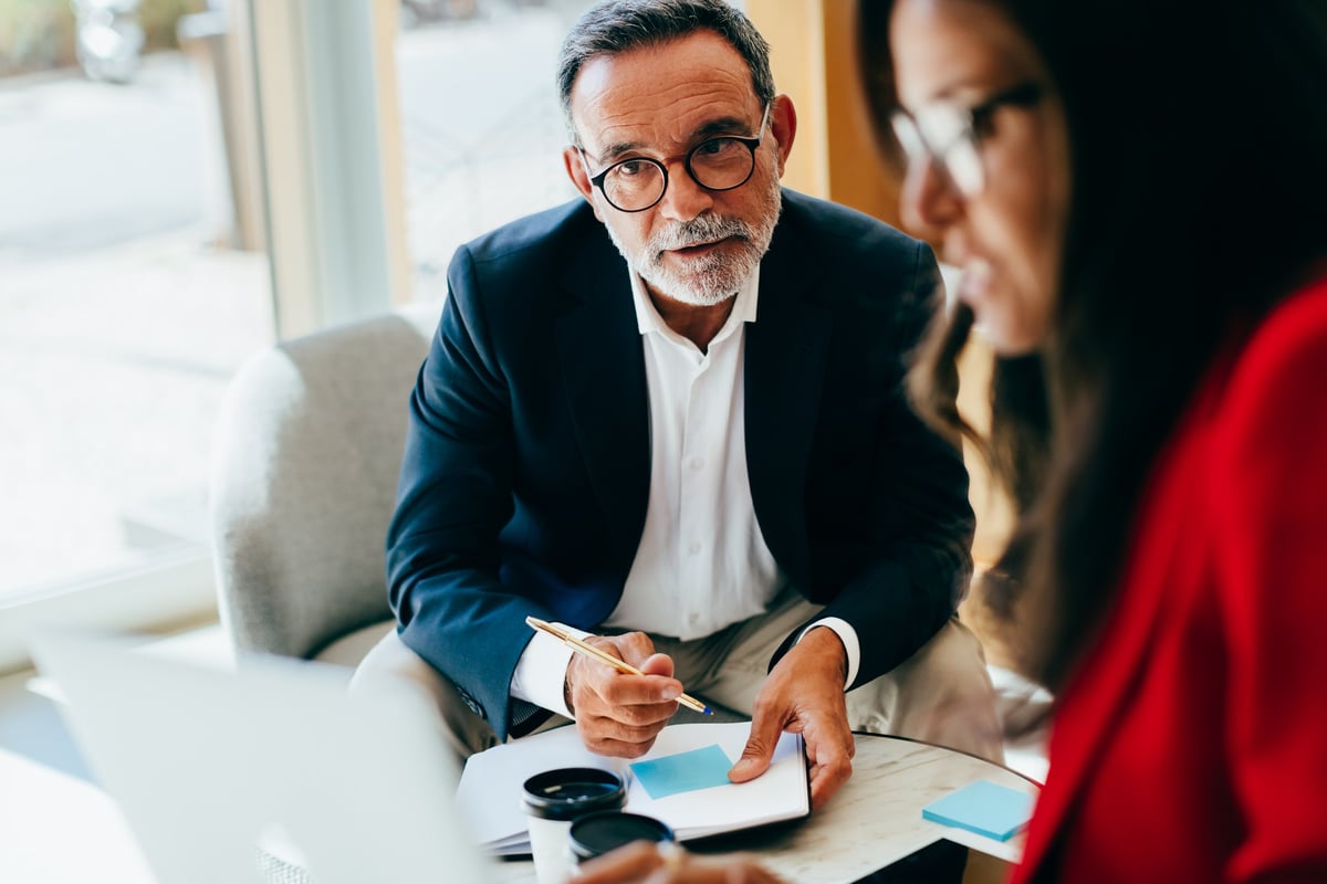 Marketing consultant meeting with small business owner to discuss growth strategy